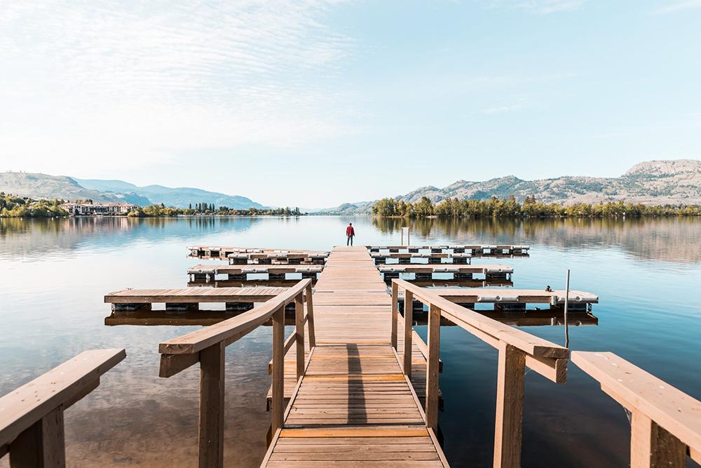 person on a dock in osoyoos on a beautiful sunny day.